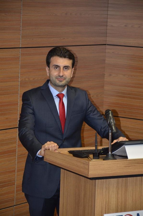 Dr. Abdeen Shaker lecturing at a podium.